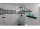 Modern shower with black trim, glass door and decorative tile at 3520 E Ludlow Dr, Phoenix, AZ 85032