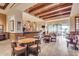 Inviting dining area with wood floors, exposed beam ceiling, and access to outdoor patio at 3720 N 150Th Ct, Goodyear, AZ 85395