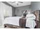 Cozy bedroom featuring a bed with a decorative wooden headboard and neutral decor at 3839 E Dublin St, Gilbert, AZ 85295