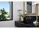 Modern bathroom showcasing a black countertop sink with a gold faucet and an ornate mirror at 4120 N 44Th Pl, Phoenix, AZ 85018