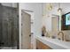 Stylish bathroom with a double sink vanity, modern lighting, and a glass-enclosed shower at 4120 N 44Th Pl, Phoenix, AZ 85018