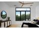 Bright bedroom with large window offering a view of mature trees, plus modern furnishings at 4120 N 44Th Pl, Phoenix, AZ 85018
