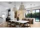 Spacious dining area adjacent to the kitchen, featuring modern pendant lights and stylish decor at 4120 N 44Th Pl, Phoenix, AZ 85018