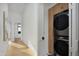Bright hallway leads to laundry room with a stacked washer and dryer, plus extra storage cabinets at 4120 N 44Th Pl, Phoenix, AZ 85018