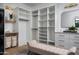 Spacious walk-in closet with custom shelving, seating, and built-in storage at 4120 N 44Th Pl, Phoenix, AZ 85018
