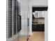 Modern wine cellar with glass door and black wet bar featuring gold hardware and a marble countertop at 4120 N 44Th Pl, Phoenix, AZ 85018