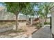 A backyard features a landscaped terrace, privacy wall, mature trees, and metal gates in this home's outdoor living space at 4225 N 21St St # 22, Phoenix, AZ 85016