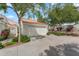 Charming home featuring a two-car garage, driveway, and desert landscaping, all set against a backdrop of blue sky and mature trees at 4225 N 21St St # 22, Phoenix, AZ 85016