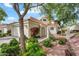 Charming home featuring a two-car garage, driveway, and desert landscaping, all set against a backdrop of blue sky and mature trees at 4225 N 21St St # 22, Phoenix, AZ 85016