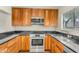 Kitchen features stainless steel appliances, wood cabinets, and sleek black countertops at 4225 N 21St St # 22, Phoenix, AZ 85016