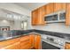 Open kitchen bar, wood cabinets, stainless appliances, and granite counters at 4225 N 21St St # 22, Phoenix, AZ 85016