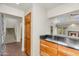 Kitchen bar area boasts wood cabinets and black granite countertops, open to the living space at 4225 N 21St St # 22, Phoenix, AZ 85016