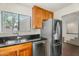 Kitchen featuring stainless steel appliances, wood cabinets, and a granite countertop at 4225 N 21St St # 22, Phoenix, AZ 85016