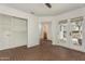 Spacious living area with brick floors, french doors, white walls, built-in shelving, and natural light at 4225 N 21St St # 22, Phoenix, AZ 85016