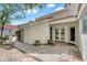 This outdoor patio features white stucco walls, french doors, and lush plantings. An attractive and functional outdoor living space at 4225 N 21St St # 22, Phoenix, AZ 85016