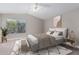 Comfortable bedroom with a ceiling fan, large window and neutral decor at 4714 E Angela Dr, Phoenix, AZ 85032
