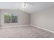Bright, spacious bedroom features soft carpeting and a view to the greenery outside at 4714 E Angela Dr, Phoenix, AZ 85032
