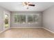 Bright room with light wood flooring and windows with views of the green yard and mature trees at 4714 E Angela Dr, Phoenix, AZ 85032