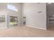 The living room features light wood flooring, high ceilings, and sliding glass doors leading to the backyard at 4714 E Angela Dr, Phoenix, AZ 85032
