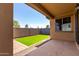 View of the patio in backyard features artificial grass and privacy wall at 5383 N 205Th Dr, Buckeye, AZ 85396