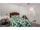Cozy bedroom featuring a full bed, a leafy green comforter, and an ensuite bathroom with a glass shower at 5383 N 205Th Dr, Buckeye, AZ 85396