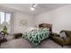 Cozy bedroom featuring a full bed, a leafy green comforter, green chair and neutral-toned walls at 5383 N 205Th Dr, Buckeye, AZ 85396