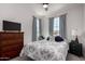 Bright bedroom with a ceiling fan, carpeted floors, and large windows at 5383 N 205Th Dr, Buckeye, AZ 85396