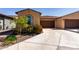Single-story home featuring desert landscaping, two-car garage and extended driveway at 5383 N 205Th Dr, Buckeye, AZ 85396