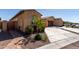 Single-story home featuring desert landscaping, two-car garage, and tiled roof at 5383 N 205Th Dr, Buckeye, AZ 85396