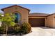 Inviting single-story home featuring desert landscaping and a charming arched window at 5383 N 205Th Dr, Buckeye, AZ 85396