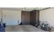This garage has built in storage cabinets and an electric car charger at 5383 N 205Th Dr, Buckeye, AZ 85396