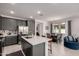 Modern kitchen featuring stainless steel appliances, a large island, and adjacent dining area at 5383 N 205Th Dr, Buckeye, AZ 85396