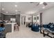 Open concept living space with modern kitchen, dining area, and inviting living room at 5383 N 205Th Dr, Buckeye, AZ 85396