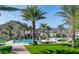Beautiful community pool area with palm trees, lush landscaping and mountain views in the background at 5383 N 205Th Dr, Buckeye, AZ 85396