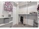 Organized walk-in closet with shelving, hanging racks and carpeted floor at 5383 N 205Th Dr, Buckeye, AZ 85396