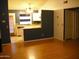Spacious living area with hardwood floors connecting to kitchen with breakfast bar seating and white cabinetry at 5704 E Aire Libre Ave # 1036, Scottsdale, AZ 85254