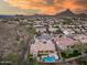 Aerial view showcases a home with a private pool and patio, complemented by desert landscaping and scenic mountain views at 5829 W Alyssa Ln, Phoenix, AZ 85083