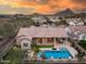 This aerial view showcases the backyard pool and spa, covered patio and mountain views at 5829 W Alyssa Ln, Phoenix, AZ 85083