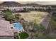 Aerial view of backyard oasis complete with pool, spa, outdoor seating, mountain views and lush landscaping at 5829 W Alyssa Ln, Phoenix, AZ 85083