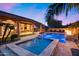 This backyard has a beautiful pool and spa, covered patio, and water feature at 5829 W Alyssa Ln, Phoenix, AZ 85083