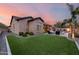 This backyard is complete with green grass, desert landscaping and a pool with a fire pit at 5829 W Alyssa Ln, Phoenix, AZ 85083