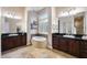 Elegant bathroom features dual vanities, a soaking tub, and travertine flooring at 5829 W Alyssa Ln, Phoenix, AZ 85083