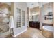 Luxurious bathroom features dual vanities, glass block details, and walk-in shower at 5829 W Alyssa Ln, Phoenix, AZ 85083