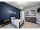 Clean bedroom with blue accent wall features a twin bed and contemporary furniture at 5829 W Alyssa Ln, Phoenix, AZ 85083