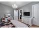 Bright bedroom featuring a vanity, chandelier, and neutral wall color at 5829 W Alyssa Ln, Phoenix, AZ 85083