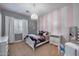 Charming bedroom with a chandelier, striped walls, and ample natural light at 5829 W Alyssa Ln, Phoenix, AZ 85083