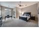 Spacious Primary bedroom with a black bed set and an adjoined office workspace at 5829 W Alyssa Ln, Phoenix, AZ 85083