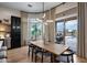 Bright dining area with modern lighting and pool views, perfect for entertaining or enjoying Gathering meals at 5829 W Alyssa Ln, Phoenix, AZ 85083