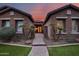 Inviting stone home with a manicured lawn and walkway to the front doors at 5829 W Alyssa Ln, Phoenix, AZ 85083