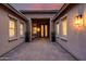 Charming courtyard with brick pavers, seating, and decorative black doors at 5829 W Alyssa Ln, Phoenix, AZ 85083